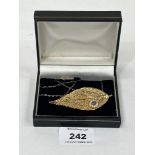 A gold plated leaf brooch/pendant on 9ct necklet chain.