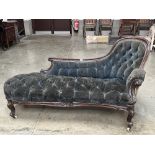 An early Victorian mahogany chaise-longue upholstered in deep buttoned blue velvet. 66" long.
