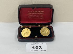 A pair of 22ct South African ½ pond coins mounted as cufflinks. The chain and dumbells 15ct. 14.9g
