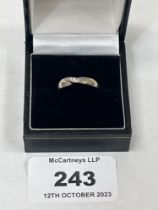An 18ct white gold diamond ring. Engraved inscription to inner band. 4.1g gross. Size N.