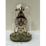 A gilt brass skeleton clock, raised on an onyx base under a glass dome; the fusee movement with
