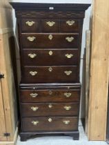 An antique oak chest on chest with brushing slide and canted sides, raised on bracket feet. 29"w x