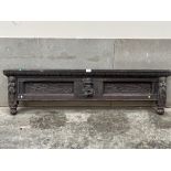 An antique carved oak bed end. 54" wide.