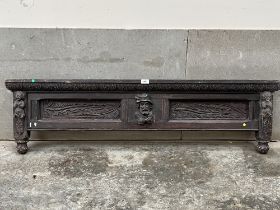 An antique carved oak bed end. 54" wide.