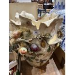 An Italian ceramic jardiniere decorated with fruit in high relief. 17" high. Losses