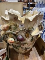 An Italian ceramic jardiniere decorated with fruit in high relief. 17" high. Losses