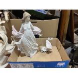 A Lladro figure of a lady with a basket of flowers, 11¾" high and a Lladro butterfly.