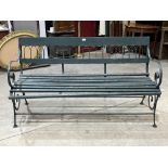 An iron and wood slatted garden bench. 58" wide.