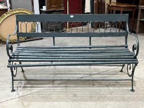 An iron and wood slatted garden bench. 58" wide.