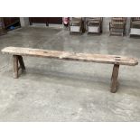 An oak bench. 85" long.