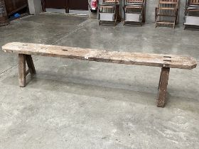 An oak bench. 85" long.