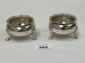 A pair of George V silver salt cellars on shell moulded feet. Chester 1921. 3" diam. 5ozs.