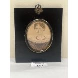 A 19th century portrait miniature of a lady with ringlet hair. The ebonised frame 5¼" high.