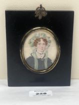 A 19th century portrait miniature of a lady wearing a bonnet. The ebonised frame 5¼" high.