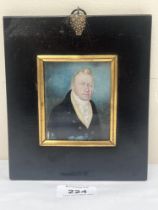 A 19th century portrait miniature of a gentleman in a black jacket and white stock. The ebonised