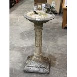 A concrete birdbath. 30" high