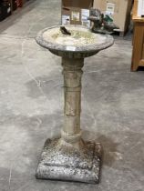 A concrete birdbath. 30" high