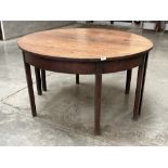 A George III mahogany dining table on square legs. 49" diam.