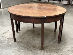 A George III mahogany dining table on square legs. 49" diam.