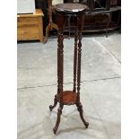 A mahogany jardiniere stand.