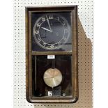 A 1930's Art - Deco style walnut wall clock, the black dial with Arabic numerals, the two train