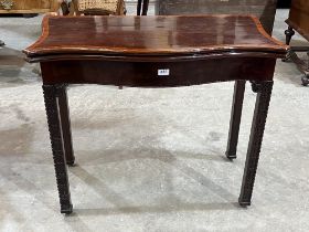 A 19th century mahogany and crossbanded serpentine card table with small drawer to the back panel,