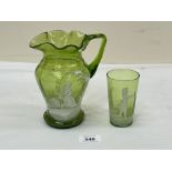 A green glass jug with overlaid decoration in the style of Mary Gregory, 6½" high; together with a