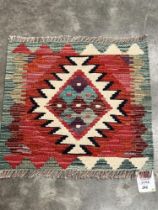 A Chobi Kilim rug. 0.44m x 0.48m.