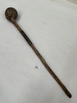 An Asian or African knobkerrie, the shaft with a series of notches. 24½" long.