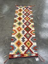 A Chobi Kilim runner. 1.96m x 0.62m