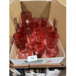 A collection of cranberry and other glassware