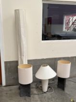 A floor lamp; a pair of stone based table lamps and a ceramic based table lamp. (4)