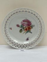 A late 19th century Furstenburg plate with reticulated rim, painted with summer flowers. 9½" diam.