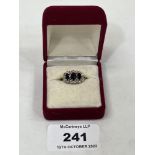 A 9ct sapphire and diamond ring. 2.6g gross. Size N.