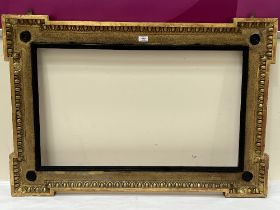 A 19th century gilt mirror or picture frame, with egg and dart moulded decoration. 30" x 44½".