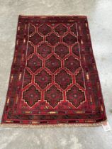 A Baluchi rug. 1.36m x 0.84m.