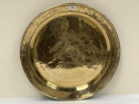 A 19th century Persian brass charger. 23" diam.