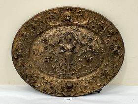 A 19th century gilt cast iron oval plaque decorated in relief. 18½" wide.