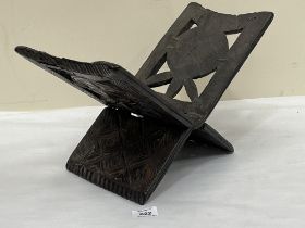 A carved hardwood folding Koran stand. 16" wide.