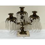 A 19th century ormolu three light lustre candelabrum hung with prismatic drops on marble base.