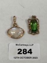 A moonstone pendant and a green stone pendant. Both apparently unmarbled.