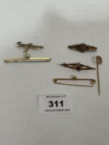 A 14ct brooch; two 9ct bar brooches and a 9ct horseshoe pin, 6g gross; with two unmarked brooches.