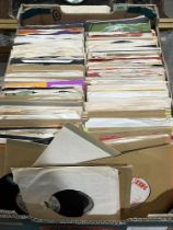 A box of over 250 1970s 7" vinyl records.