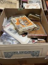 A box of trade and cigarette cards and packets.