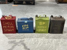 Three vintage petrol cans and an Esso Blue paraffin can.