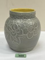 A Bretby ovoid vase, incised with flowers on a drab glaze with yellow interior. Impressed marks