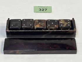 A late 19th century tortoiseshell boxed set of five gaming dice. 5" long.