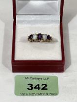 A five stone amethyst and opal ring. In gold marked 375. 3.1g gross. Size Q.