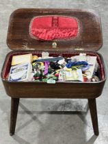 A 1950 sewing table and contents. 21½" wide.