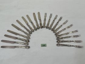 A set of cake knives and forks with loaded silver hafts.
